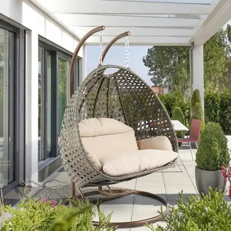 LeisureMod 2-Person Rattan Wicker Hanging Egg Chair With Stand and Cushioned Lounger